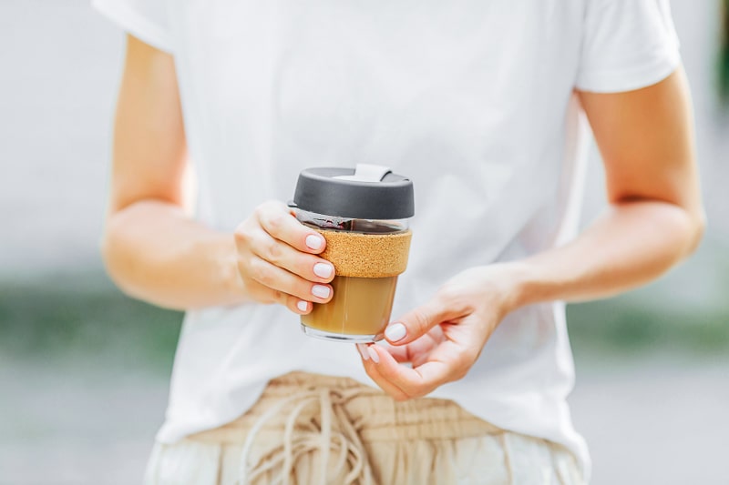 Person holding reusable coffee mug