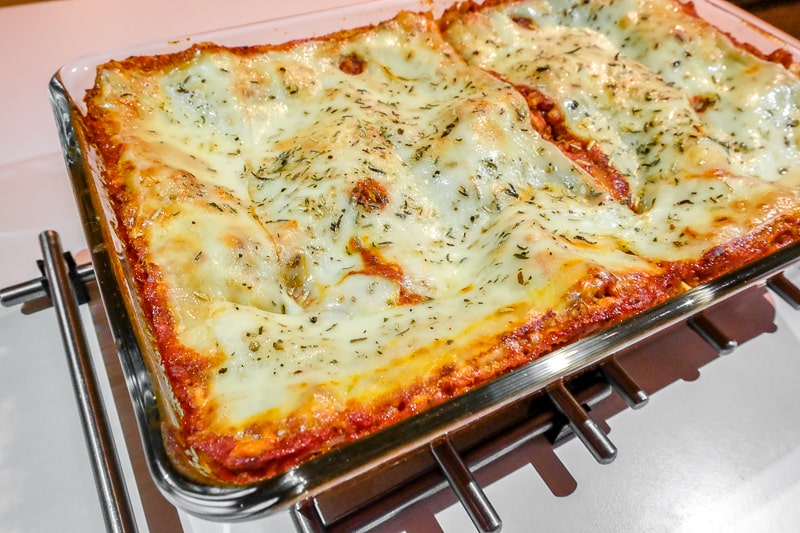 vegetarian lasagna with cheese in baking pan on table