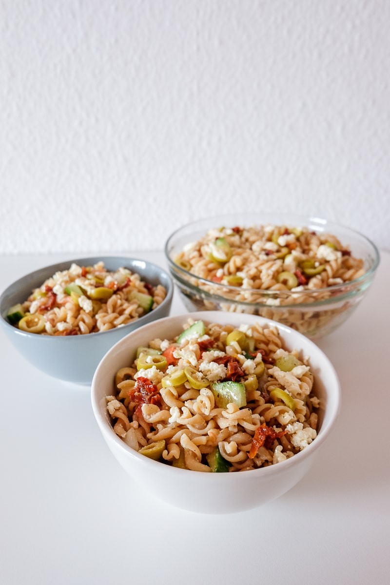 bowls of pasta salad on white table